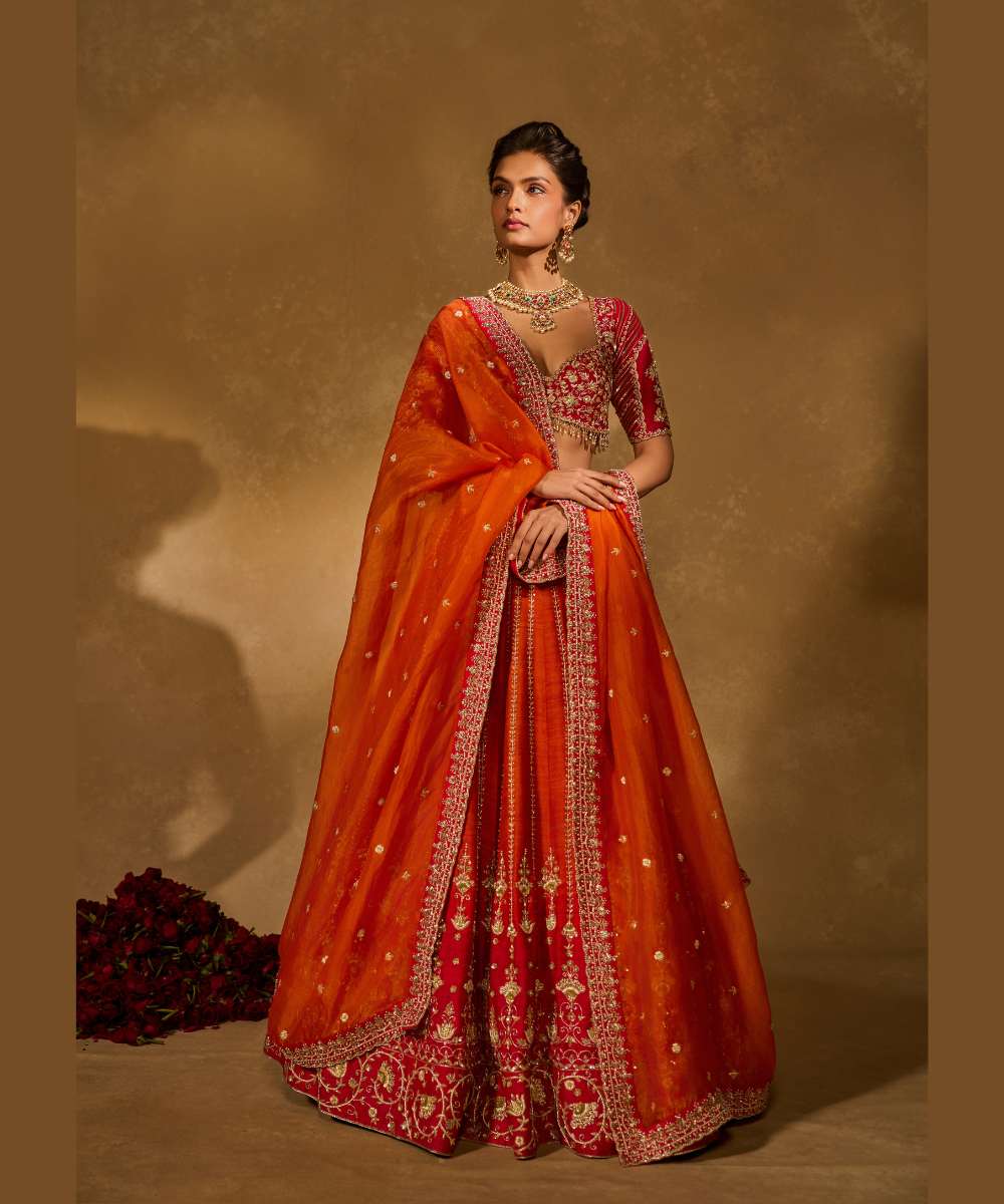 AARIANA LEHENGA - Orange to red ombré raw silk lehenga intricately embellished with zardozi, sequence ,glass beads and pearls paired with a delicately encrusted elbow-sleeve blouse - Leher by Chamee and Palak