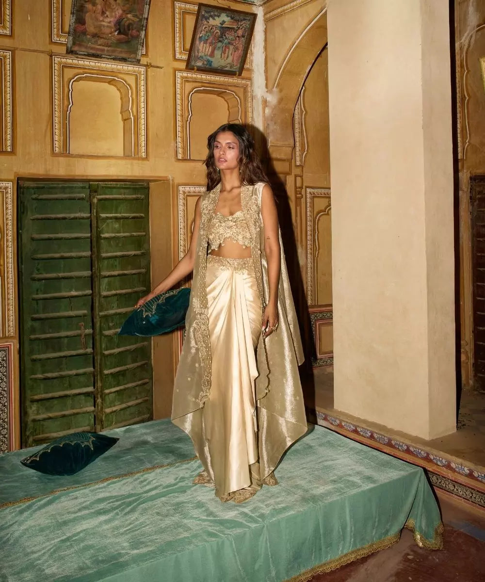 Aditi Gupta -  Champagne Gold drape Satin Skirt  Set with pure Tissue Cape