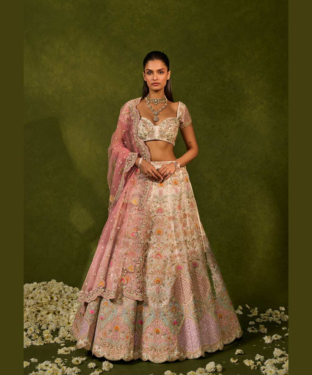 KIARA LEHENGA - Ivory organza lehenga adorned with intricate zari thread, sequence, and pearl embroidery paired with a stunning floral embellished blouse -  Leher by Chamee and Palak