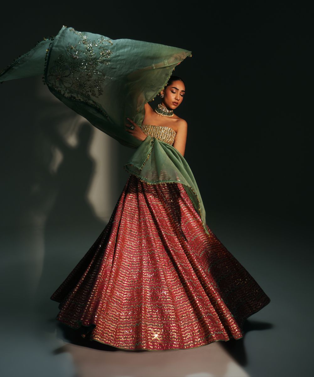 GARIMA - HAND EMBROIDERED RANI PINK LEHENGA WITH GOLDEN CORSET -  Mehfil by Mahima Mahajan