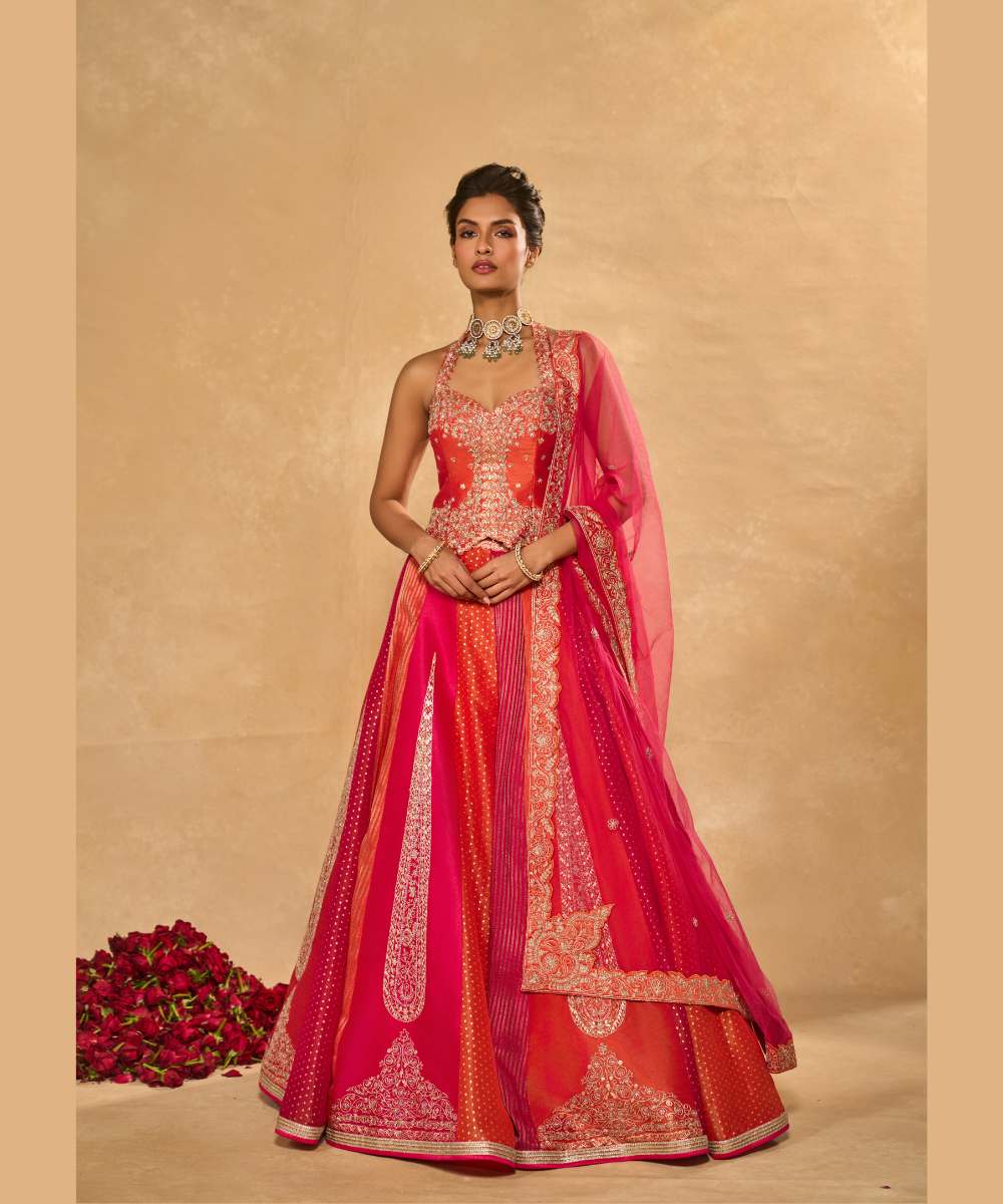 ORANGE NAINA LEHENGA - Orange and Pink dupion silk and tissue jamewar 6 kali lehenga, intricately woven and delicately encrusted with zari embroidery paired with an orange halter-neck blouse - Leher by Chamee and Palak