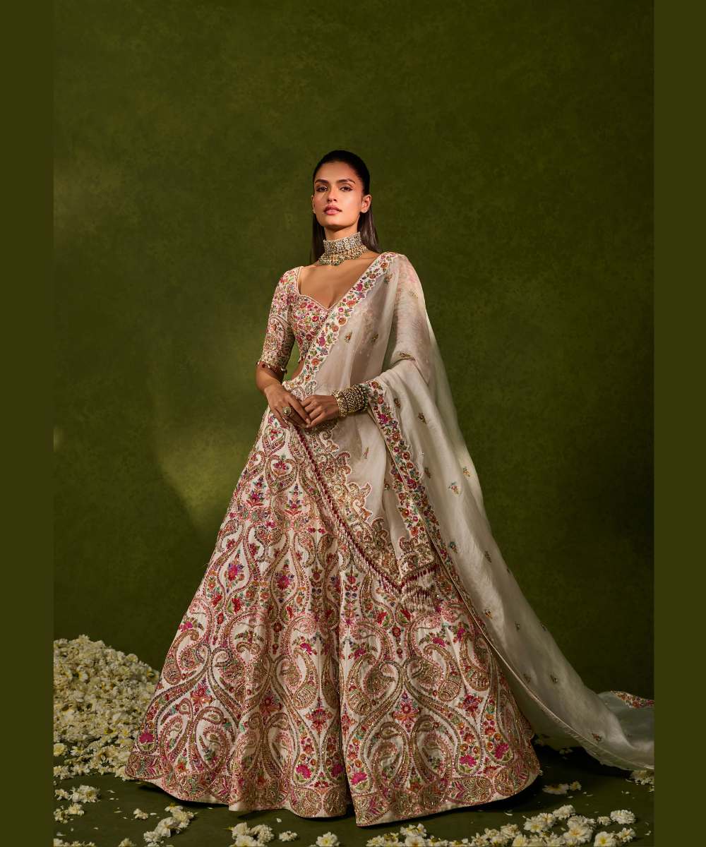 SAISHA LEHENGA - Ivory raw silk lehenga embellished with intricate floral and paisley motifs crafted in resham, zardozi, sequence -  Leher by Chamee and Palak