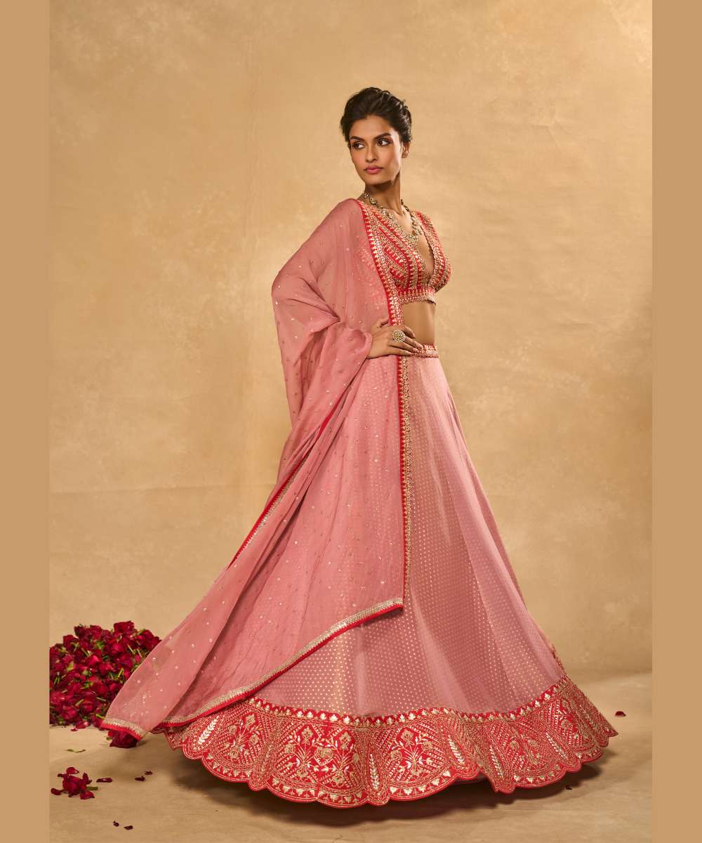 MINA DAMAN LEHENGA - Tissue jamewar lehenga accented with pita and zari embroidery along a contrast red hem paired with a delicately embroidered red plunging neck blouse - Leher by Chamee and Palak