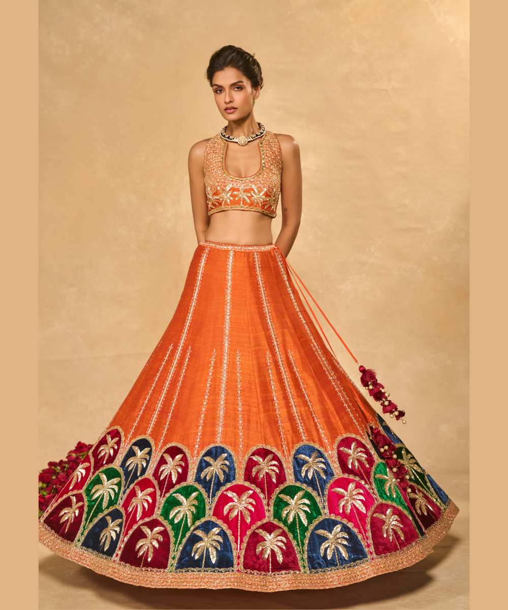 MAPLE LEHENGA - Raw silk lehenga with finely embroidered velvet palm appliqué in blue, maroon, green, and pink, highlighted with glass beads paired with a delicately embellished high-neck décolleté plunge blouse - Leher by Chamee and Palak