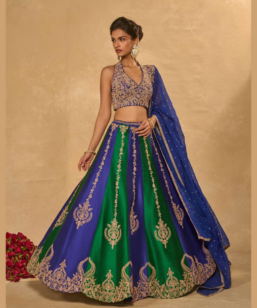 SAIRA LEHENGA - Silk lehenga embellished with luminous zari embroidery, paired with a blue halter neck blouse -  Leher by Chamee and Palak