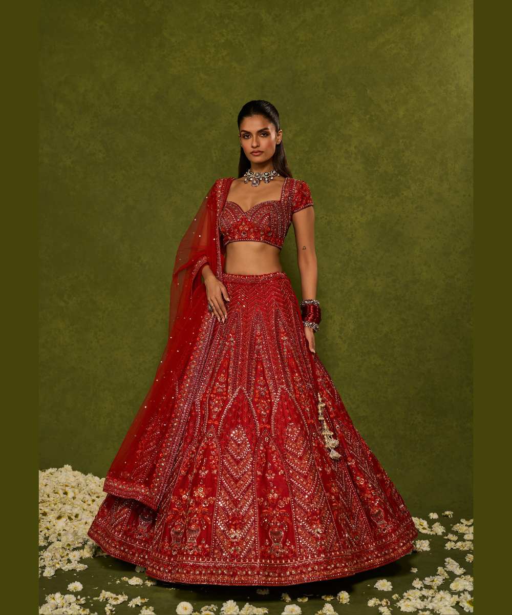 INDIRA LEHENGA - Red raw silk floral embroidered lehenga with thread, sequence, zardozi and glassbeads detailing paired with a sweetheart neck cap sleeve heavily embroidered blouse - Leher by Chamee and Palak