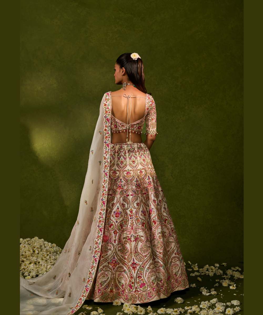 SAISHA LEHENGA - Ivory raw silk lehenga embellished with intricate floral and paisley motifs crafted in resham, zardozi, sequence -  Leher by Chamee and Palak