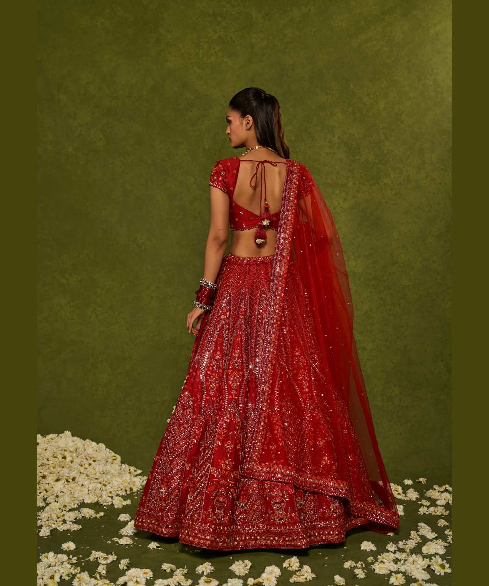 INDIRA LEHENGA - Red raw silk floral embroidered lehenga with thread, sequence, zardozi and glassbeads detailing paired with a sweetheart neck cap sleeve heavily embroidered blouse - Leher by Chamee and Palak