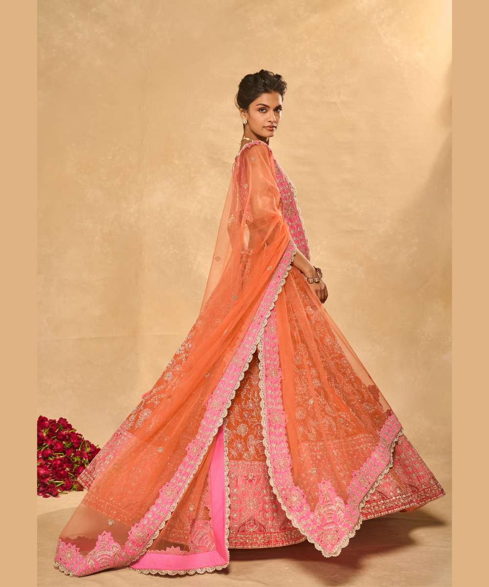 MAHIRA LEHENGA - Orange organza lehenga exquisitely embellished with a pink appliqué hem encrusted in intricate zari, resham, pearl, and glass bead paired with a delicately scalloped V-neck blouse - Leher by Chamee and Palak