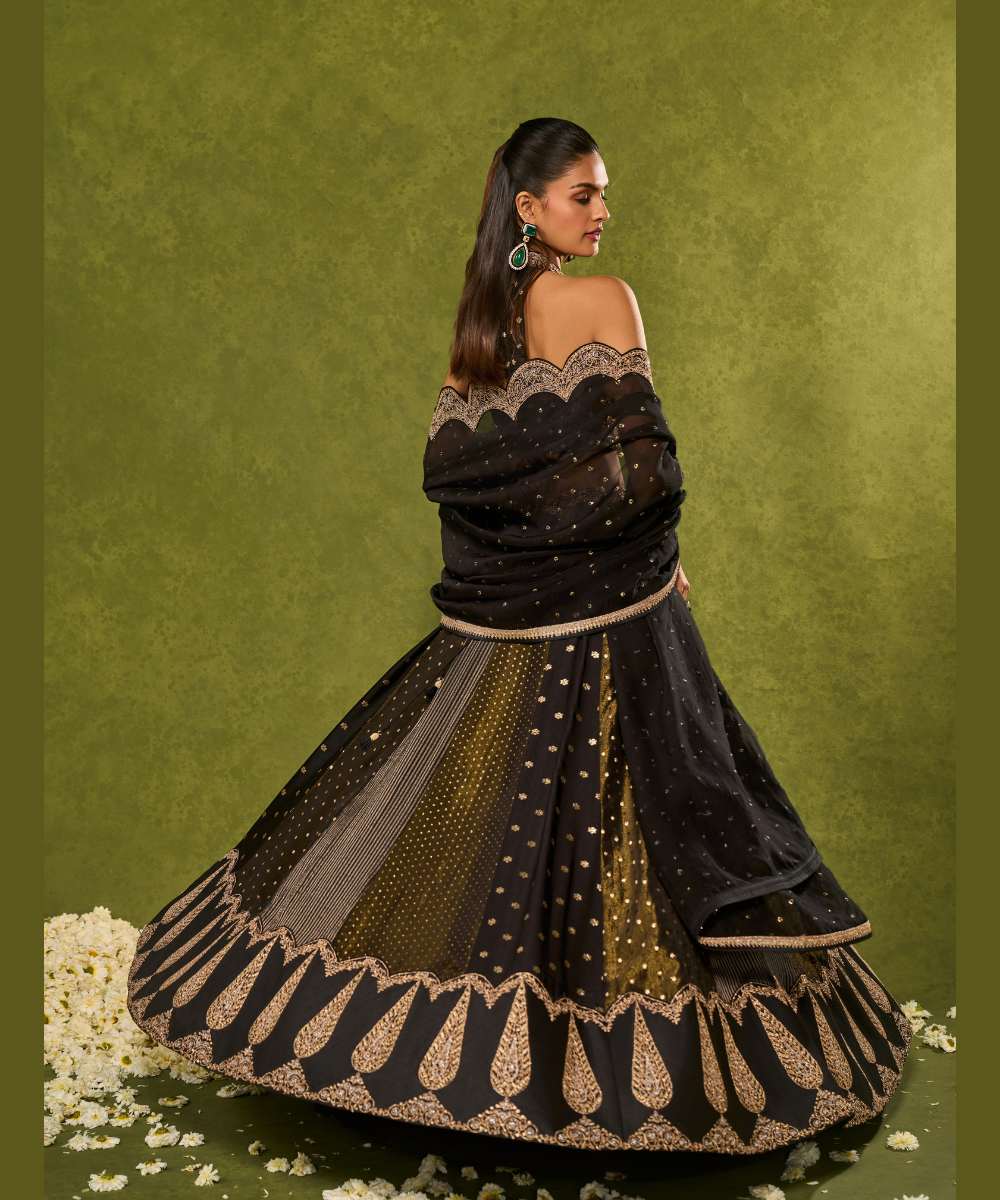 NANDANA LEHENGA - Black tissue woven jamewar lehenga delicately embroidered with a zari hem paired with a richly embroidered halter-neck blouse - Leher by Chamee and Palak