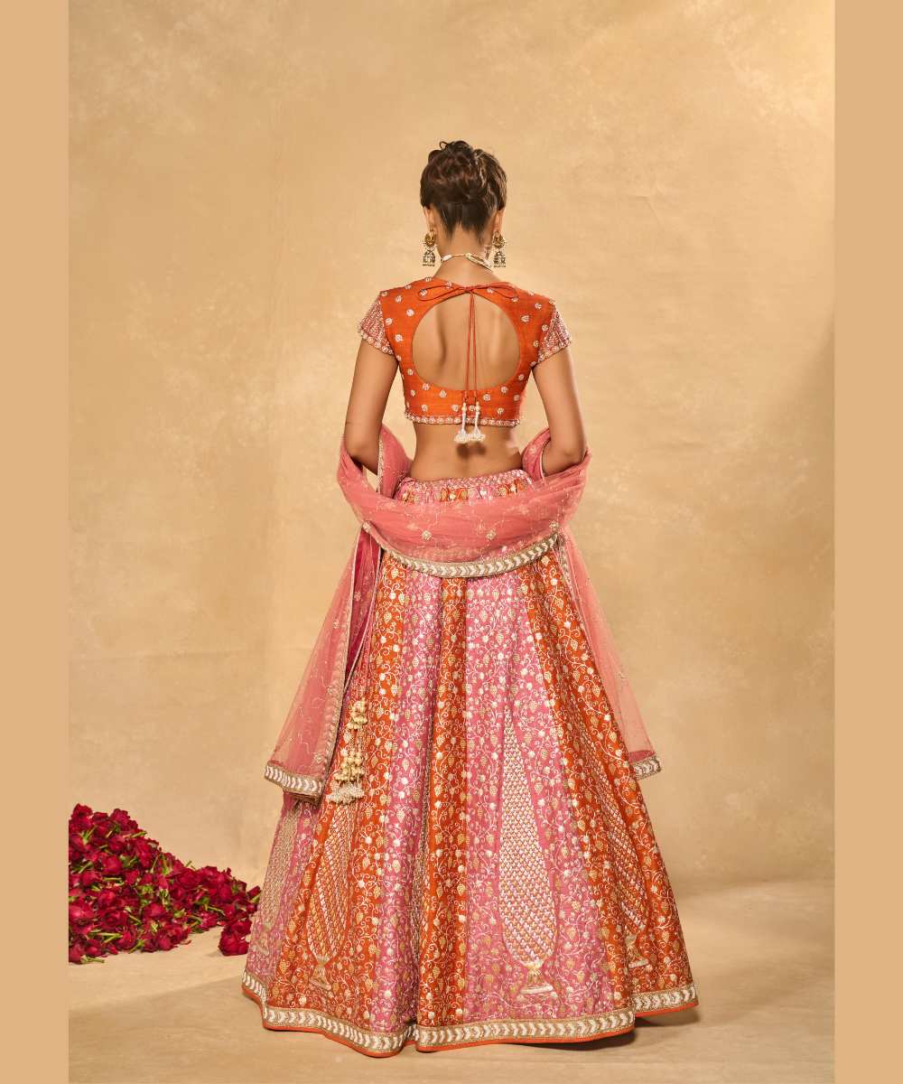 SABA LEHENGA - Mauve Pink and Orange lehenga intricately embroidered with pita, glass beads, stones, pearls, zardozi, and zari paired with a delicately embellished sweetheart neck cap sleeve blouse -  Leher by Chamee and Palak