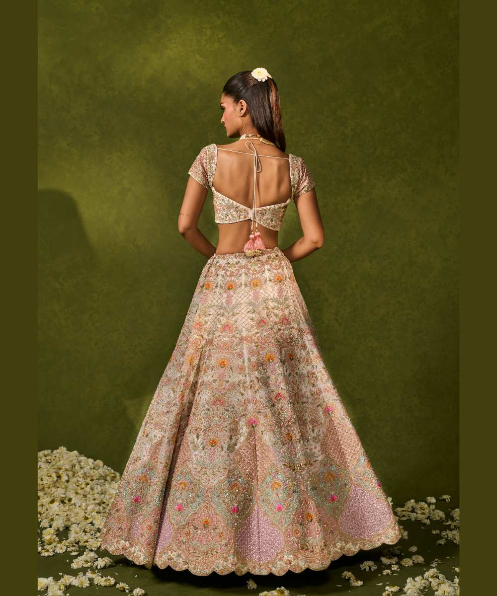 KIARA LEHENGA - Ivory organza lehenga adorned with intricate zari thread, sequence, and pearl embroidery paired with a stunning floral embellished blouse -  Leher by Chamee and Palak