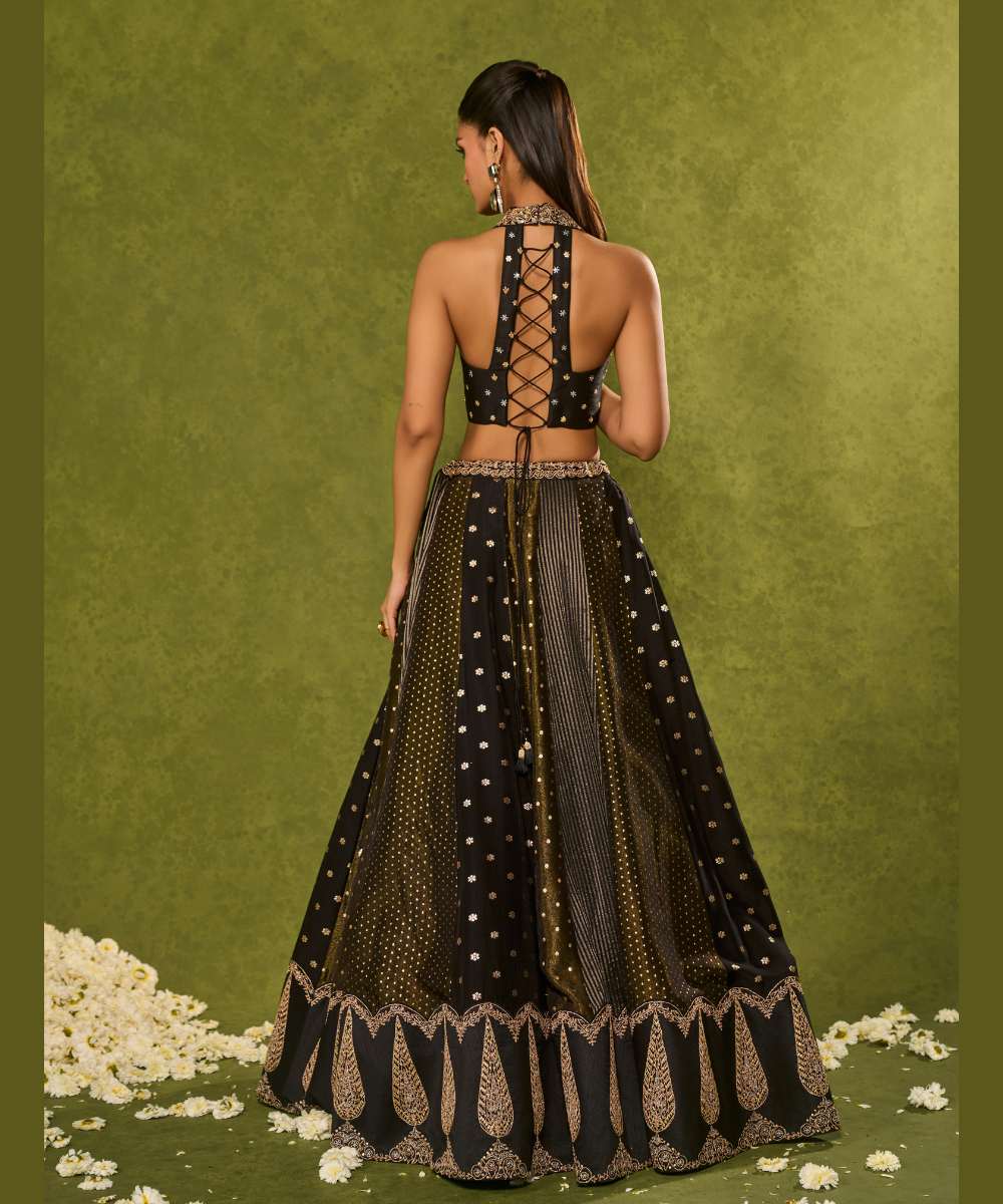 NANDANA LEHENGA - Black tissue woven jamewar lehenga delicately embroidered with a zari hem paired with a richly embroidered halter-neck blouse - Leher by Chamee and Palak
