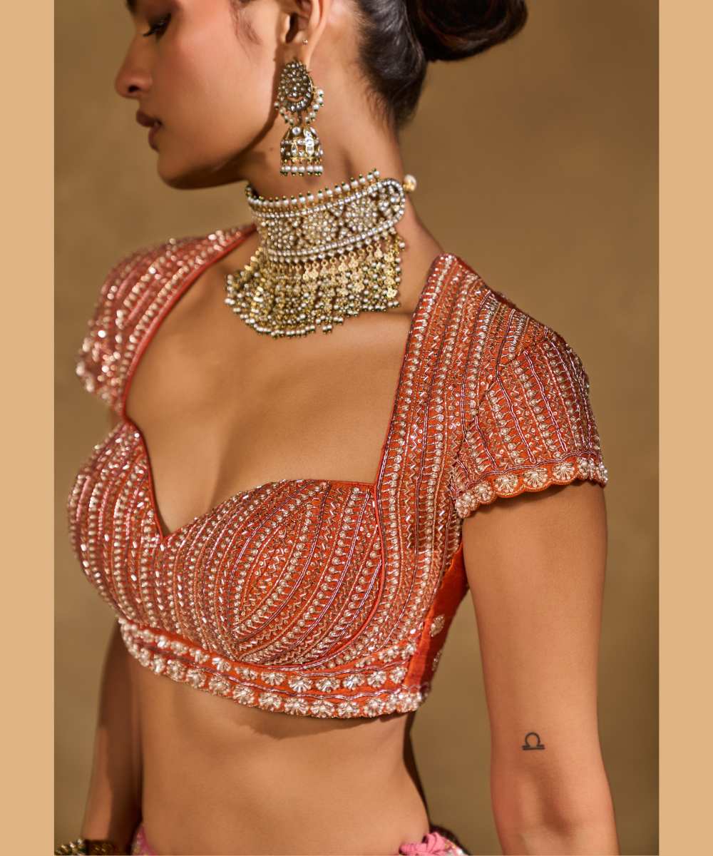 SABA LEHENGA - Mauve Pink and Orange lehenga intricately embroidered with pita, glass beads, stones, pearls, zardozi, and zari paired with a delicately embellished sweetheart neck cap sleeve blouse -  Leher by Chamee and Palak
