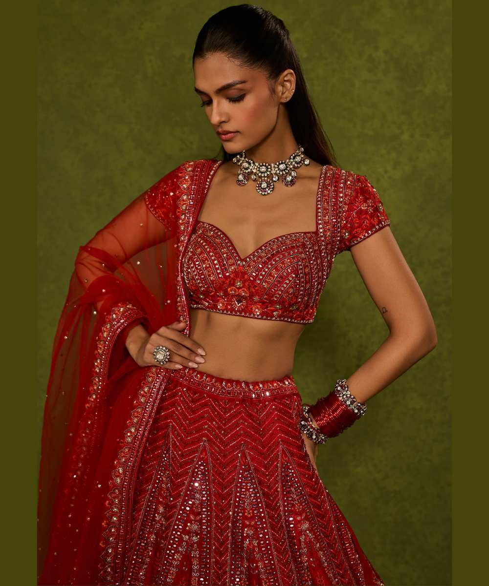 INDIRA LEHENGA - Red raw silk floral embroidered lehenga with thread, sequence, zardozi and glassbeads detailing paired with a sweetheart neck cap sleeve heavily embroidered blouse - Leher by Chamee and Palak