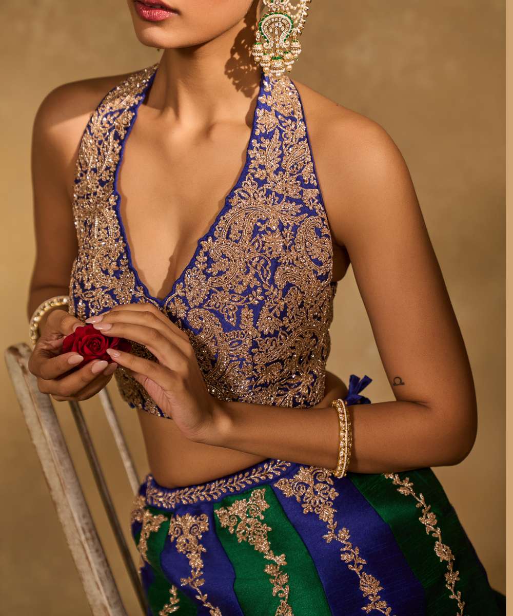 SAIRA LEHENGA - Silk lehenga embellished with luminous zari embroidery, paired with a blue halter neck blouse -  Leher by Chamee and Palak