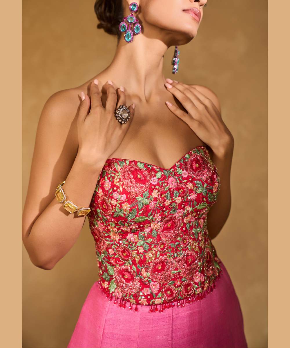 TANYA OMBRE LEHENGA - Pink tor Red ombré lehenga, adorned with delicately embroidered floral motifs in resham and zari paired with a red raw silk corset blouse - Leher by Chamee and Palak
