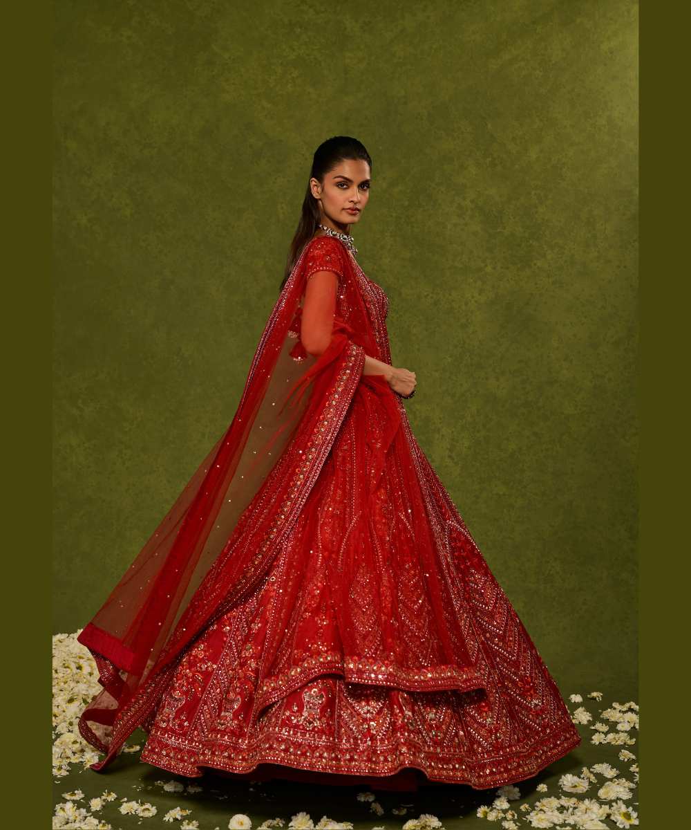 INDIRA LEHENGA - Red raw silk floral embroidered lehenga with thread, sequence, zardozi and glassbeads detailing paired with a sweetheart neck cap sleeve heavily embroidered blouse - Leher by Chamee and Palak