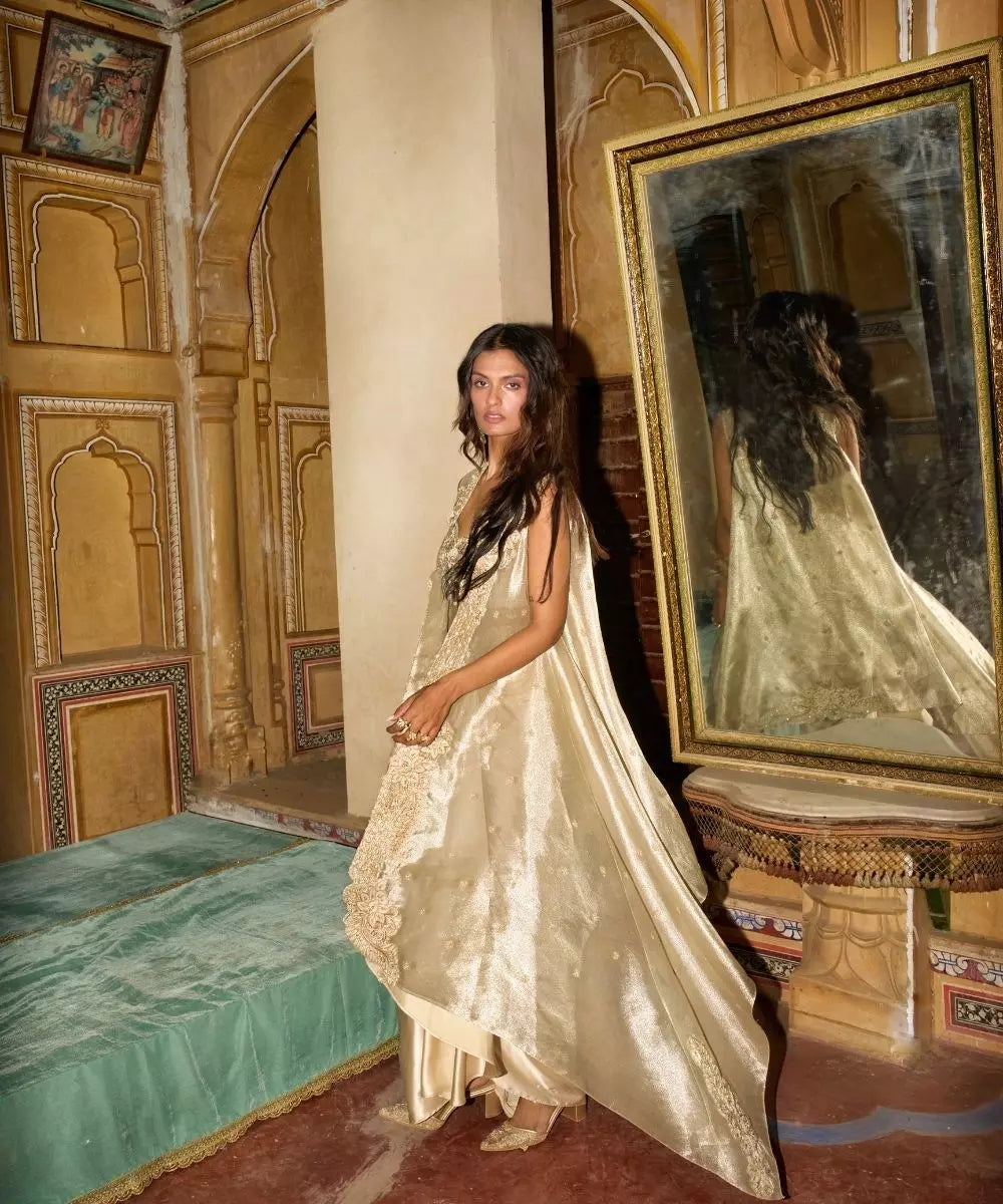 Aditi Gupta -  Champagne Gold drape Satin Skirt  Set with pure Tissue Cape