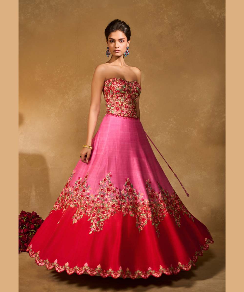 TANYA OMBRE LEHENGA - Pink tor Red ombré lehenga, adorned with delicately embroidered floral motifs in resham and zari paired with a red raw silk corset blouse - Leher by Chamee and Palak