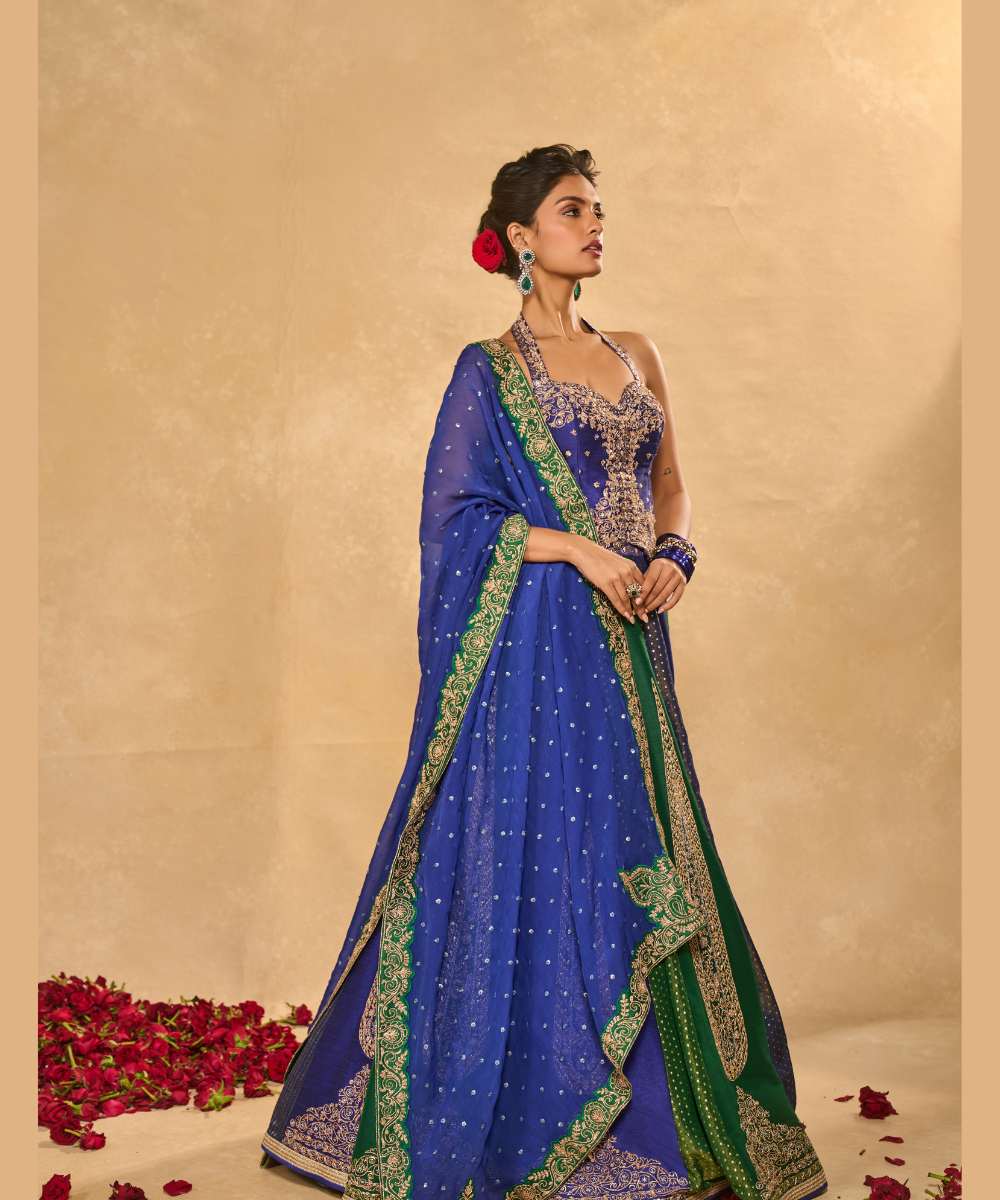 BLUE NAINA LEHENGA - Blue and green dupion silk and tissue jamewar 10 kali lehenga, intricately woven and delicately encrusted with zari embroidery paired with a blue halter-neck blouse - Leher by Chamee and Palak