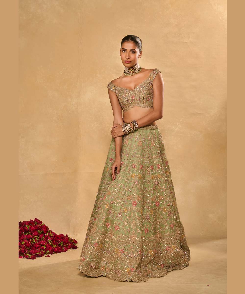 REVATI LEHENGA - Light Sage Green organza lehenga adorned with intricate zari thread, sequence, and pearl embroidery paired with a stunning floral-embellished off-shoulder blouse - Leher by Chamee and Palak