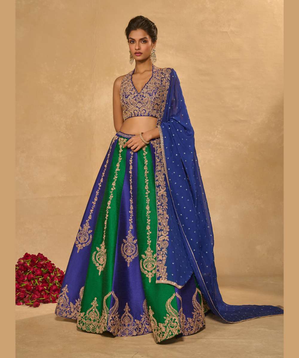 SAIRA LEHENGA - Silk lehenga embellished with luminous zari embroidery, paired with a blue halter neck blouse -  Leher by Chamee and Palak