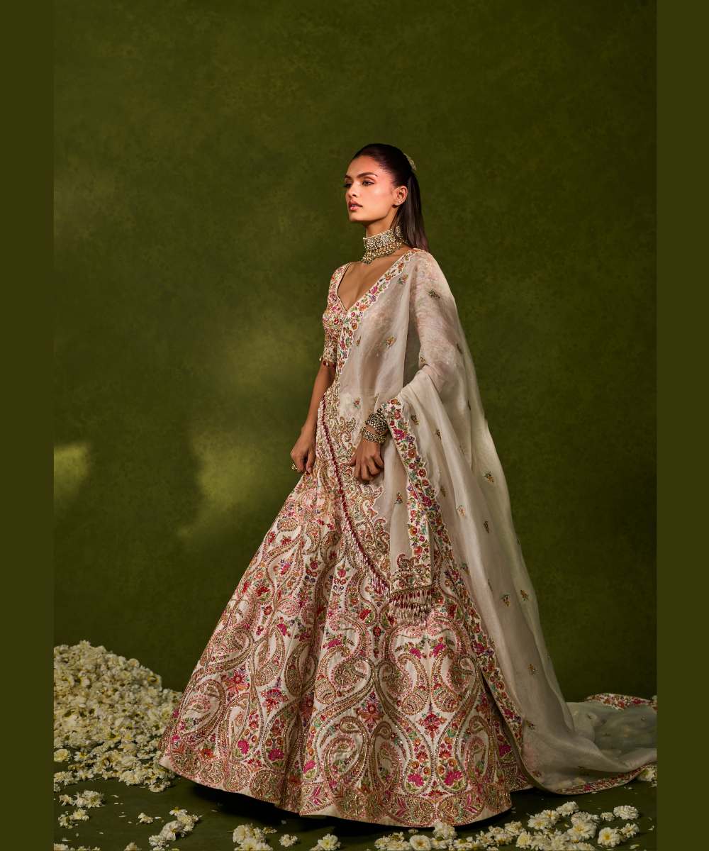 SAISHA LEHENGA - Ivory raw silk lehenga embellished with intricate floral and paisley motifs crafted in resham, zardozi, sequence -  Leher by Chamee and Palak
