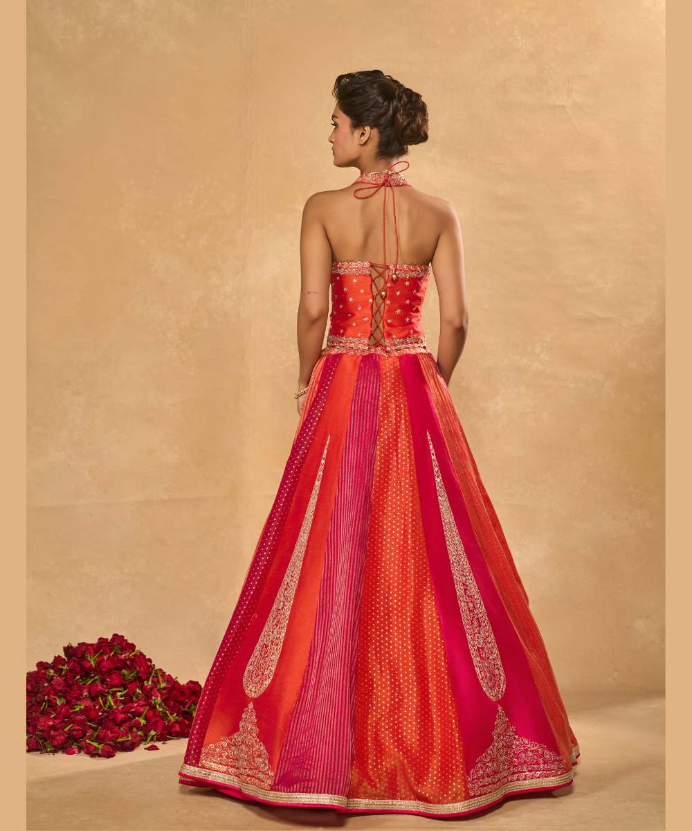 ORANGE NAINA LEHENGA - Orange and Pink dupion silk and tissue jamewar 6 kali lehenga, intricately woven and delicately encrusted with zari embroidery paired with an orange halter-neck blouse - Leher by Chamee and Palak