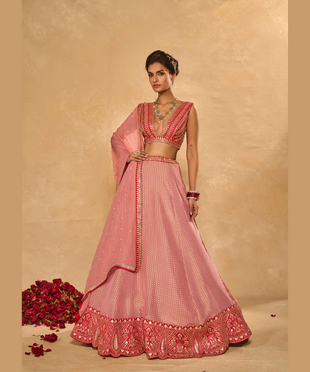 MINA DAMAN LEHENGA - Tissue jamewar lehenga accented with pita and zari embroidery along a contrast red hem paired with a delicately embroidered red plunging neck blouse - Leher by Chamee and Palak