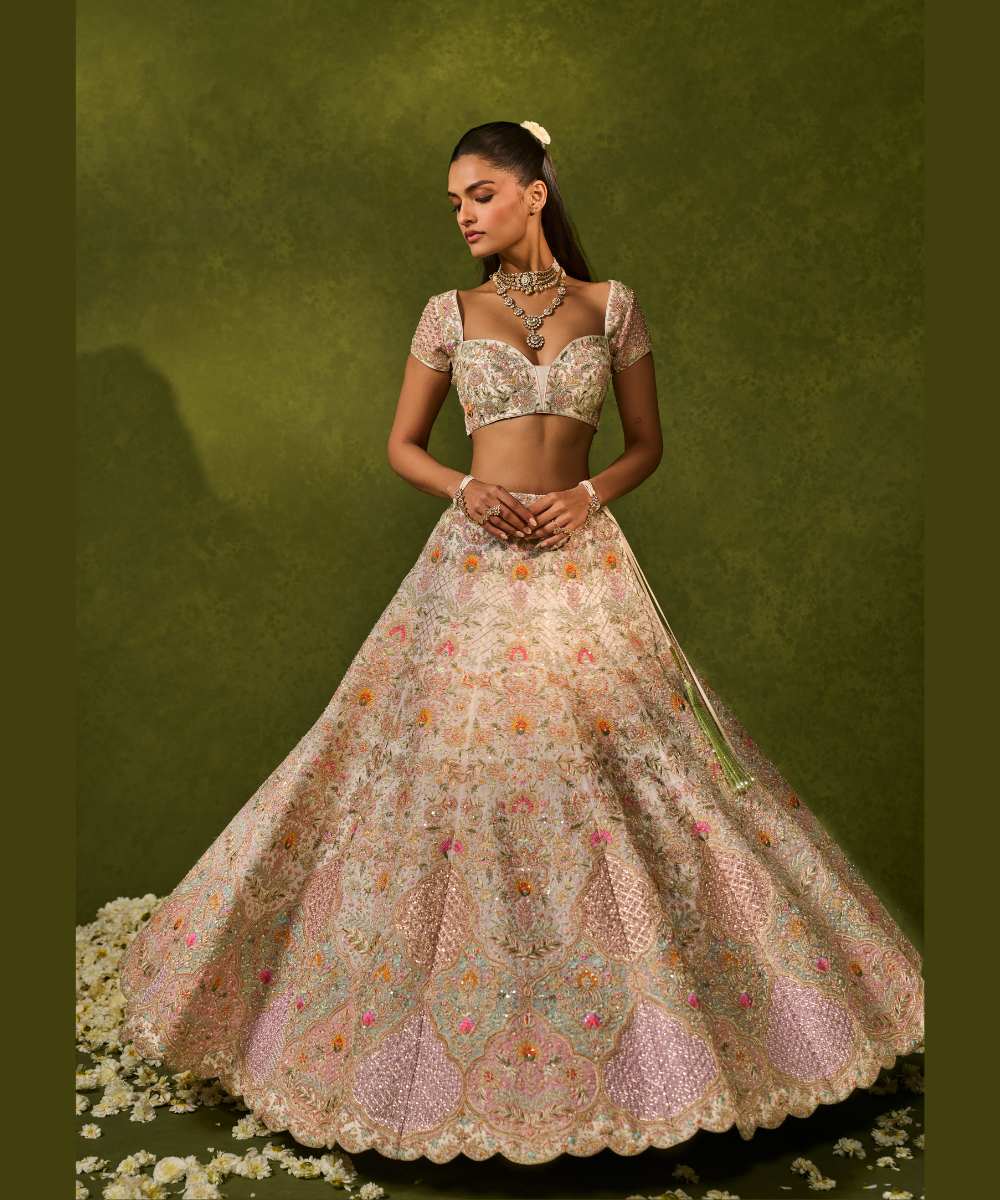 KIARA LEHENGA - Ivory organza lehenga adorned with intricate zari thread, sequence, and pearl embroidery paired with a stunning floral embellished blouse -  Leher by Chamee and Palak