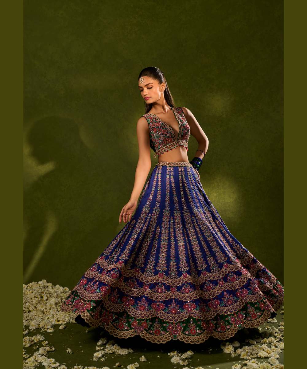 OORJA LEHENGA - Blue and green soft silk lehenga exquisitely embellished with vibrant resham, zari, pearls, and sequence work, in a graceful scallop pattern paired with a green, intricately embroidered plunging-neck blouse - Leher by Chamee and Palak