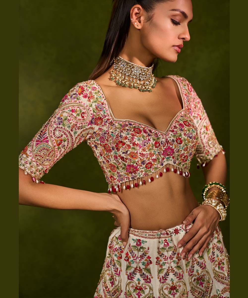 SAISHA LEHENGA - Ivory raw silk lehenga embellished with intricate floral and paisley motifs crafted in resham, zardozi, sequence -  Leher by Chamee and Palak
