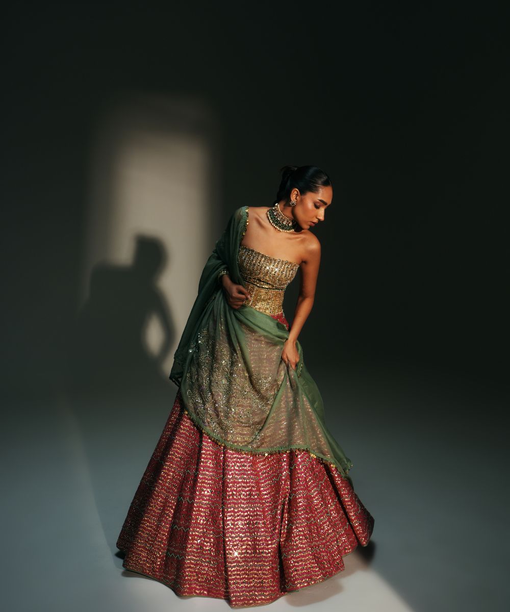 GARIMA - HAND EMBROIDERED RANI PINK LEHENGA WITH GOLDEN CORSET -  Mehfil by Mahima Mahajan