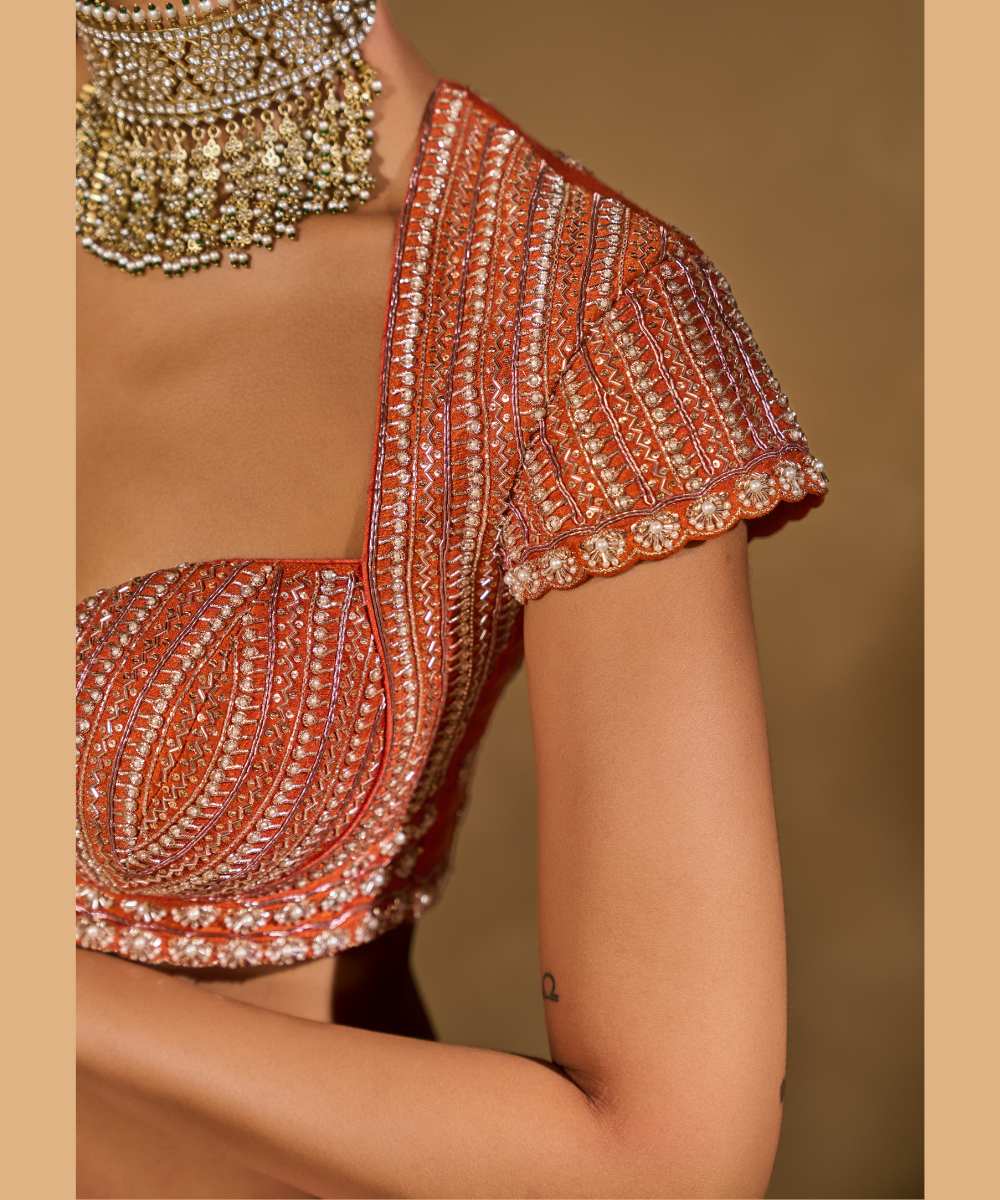 SABA LEHENGA - Mauve Pink and Orange lehenga intricately embroidered with pita, glass beads, stones, pearls, zardozi, and zari paired with a delicately embellished sweetheart neck cap sleeve blouse -  Leher by Chamee and Palak