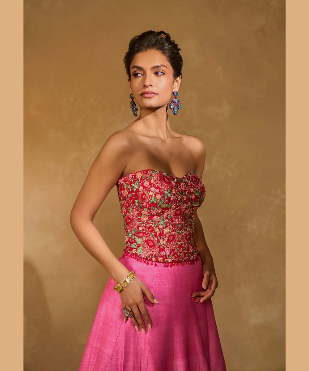 TANYA OMBRE LEHENGA - Pink tor Red ombré lehenga, adorned with delicately embroidered floral motifs in resham and zari paired with a red raw silk corset blouse - Leher by Chamee and Palak