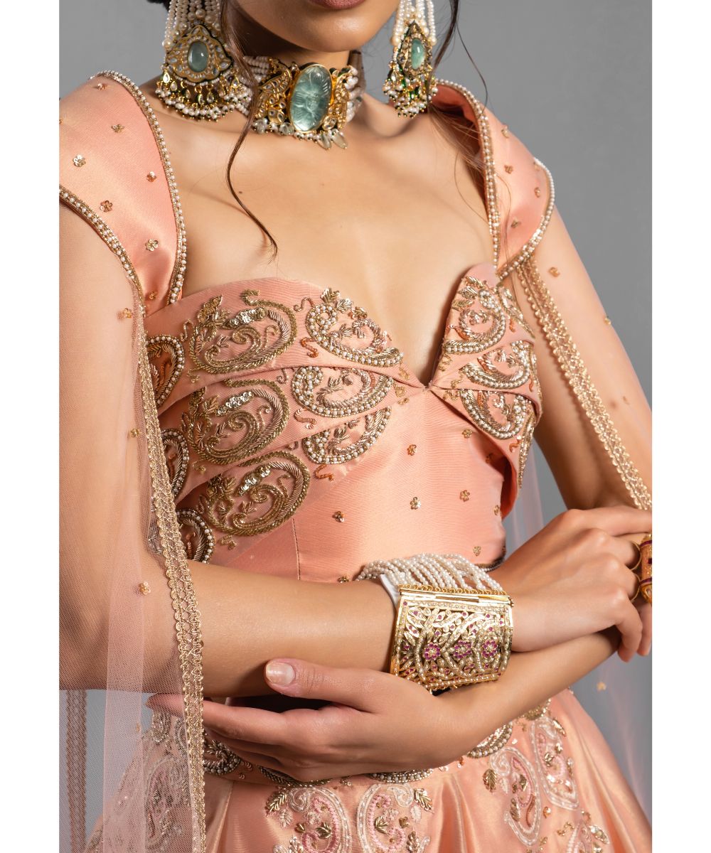 Peach tissue Lehenga with a Draped Blouse
