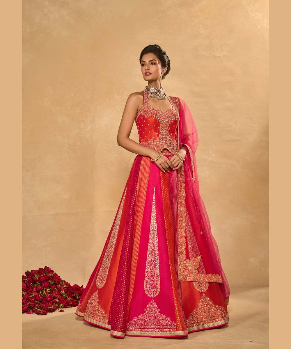 ORANGE NAINA LEHENGA - Orange and Pink dupion silk and tissue jamewar 6 kali lehenga, intricately woven and delicately encrusted with zari embroidery paired with an orange halter-neck blouse - Leher by Chamee and Palak