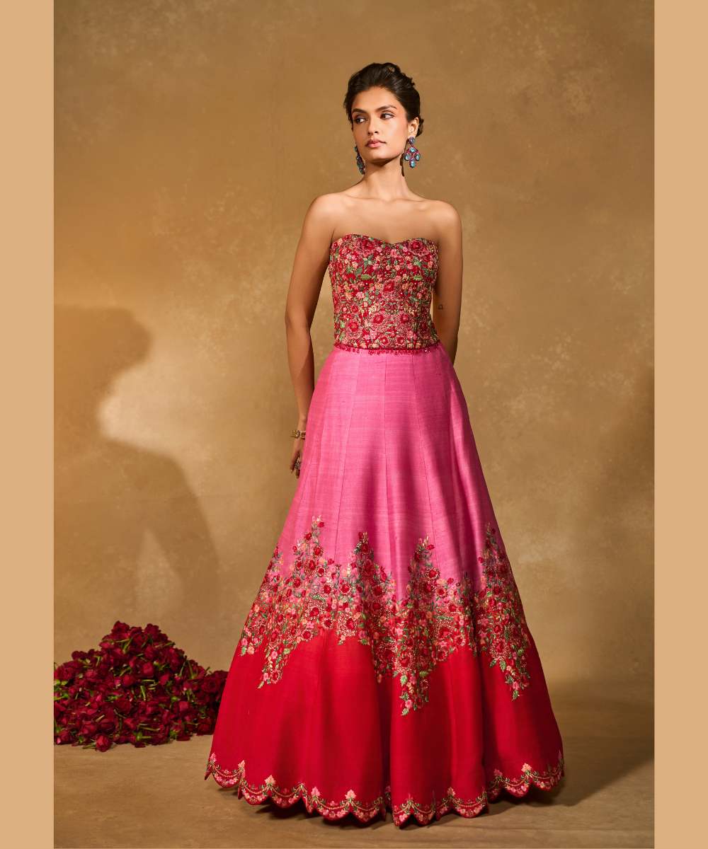 TANYA OMBRE LEHENGA - Pink tor Red ombré lehenga, adorned with delicately embroidered floral motifs in resham and zari paired with a red raw silk corset blouse - Leher by Chamee and Palak