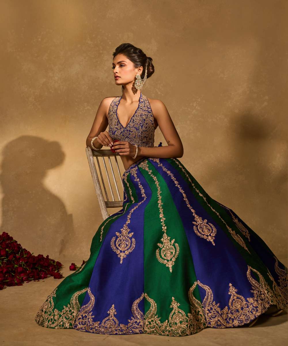 SAIRA LEHENGA - Silk lehenga embellished with luminous zari embroidery, paired with a blue halter neck blouse -  Leher by Chamee and Palak