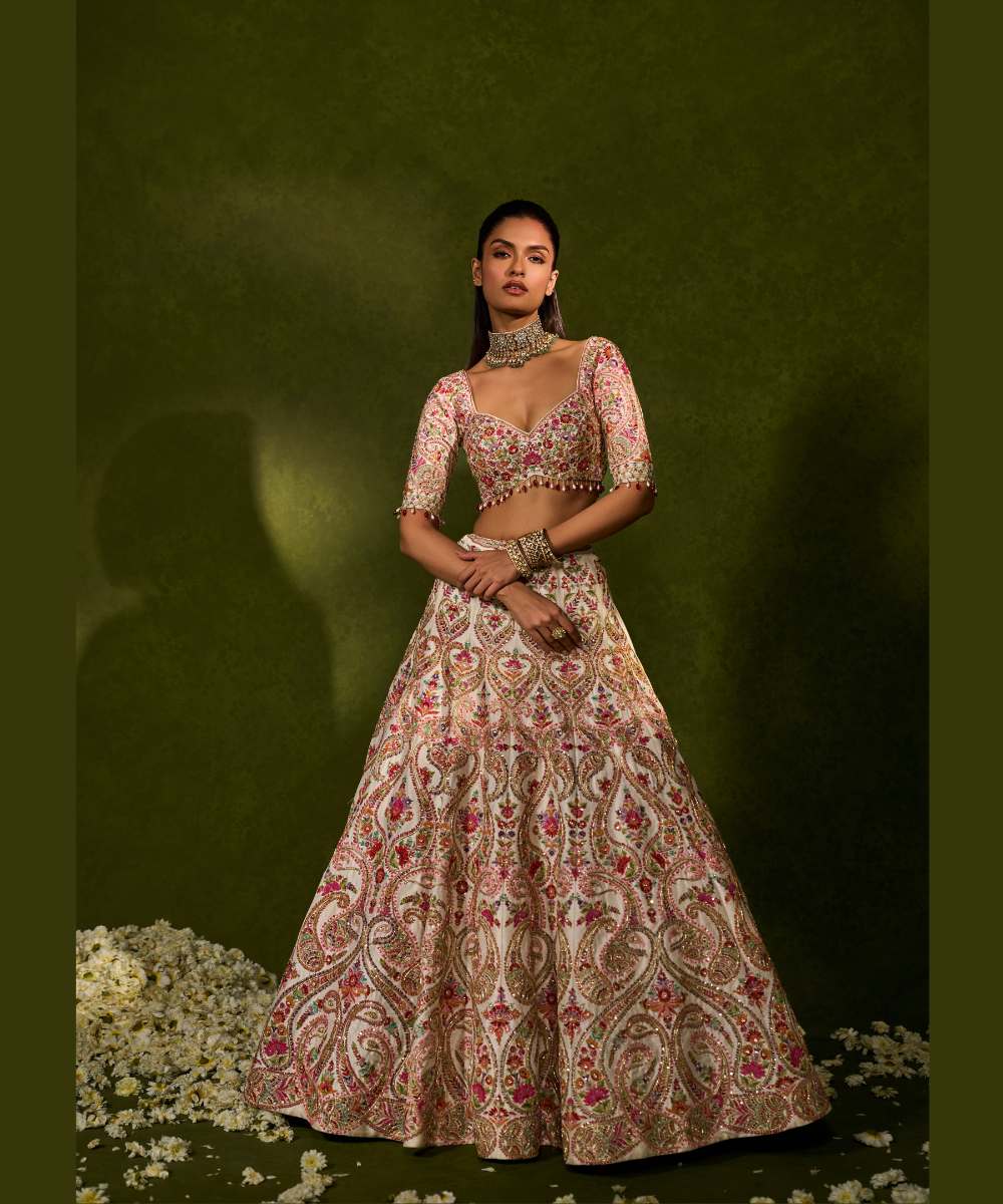 SAISHA LEHENGA - Ivory raw silk lehenga embellished with intricate floral and paisley motifs crafted in resham, zardozi, sequence -  Leher by Chamee and Palak