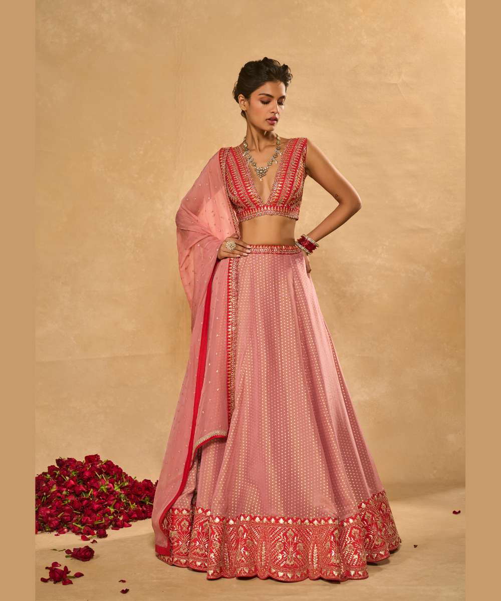 MINA DAMAN LEHENGA - Tissue jamewar lehenga accented with pita and zari embroidery along a contrast red hem paired with a delicately embroidered red plunging neck blouse - Leher by Chamee and Palak