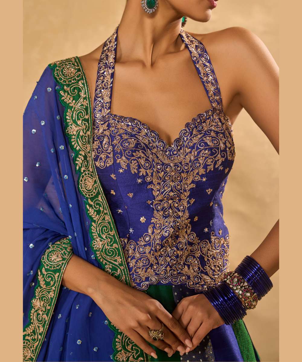 BLUE NAINA LEHENGA - Blue and green dupion silk and tissue jamewar 10 kali lehenga, intricately woven and delicately encrusted with zari embroidery paired with a blue halter-neck blouse - Leher by Chamee and Palak