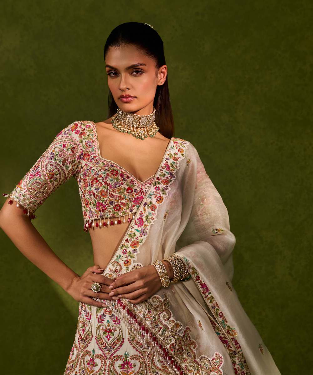 SAISHA LEHENGA - Ivory raw silk lehenga embellished with intricate floral and paisley motifs crafted in resham, zardozi, sequence -  Leher by Chamee and Palak