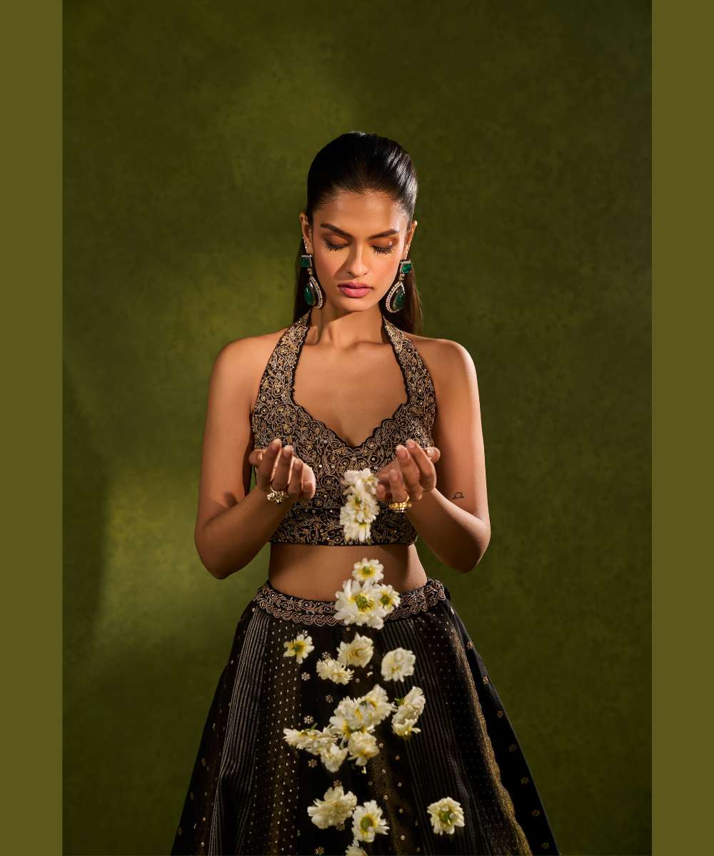 NANDANA LEHENGA - Black tissue woven jamewar lehenga delicately embroidered with a zari hem paired with a richly embroidered halter-neck blouse - Leher by Chamee and Palak