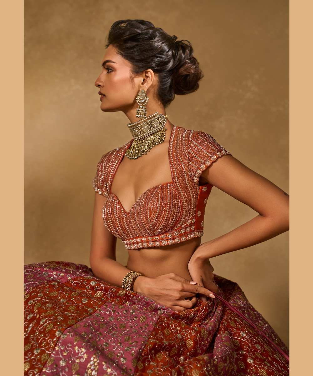 SABA LEHENGA - Mauve Pink and Orange lehenga intricately embroidered with pita, glass beads, stones, pearls, zardozi, and zari paired with a delicately embellished sweetheart neck cap sleeve blouse -  Leher by Chamee and Palak