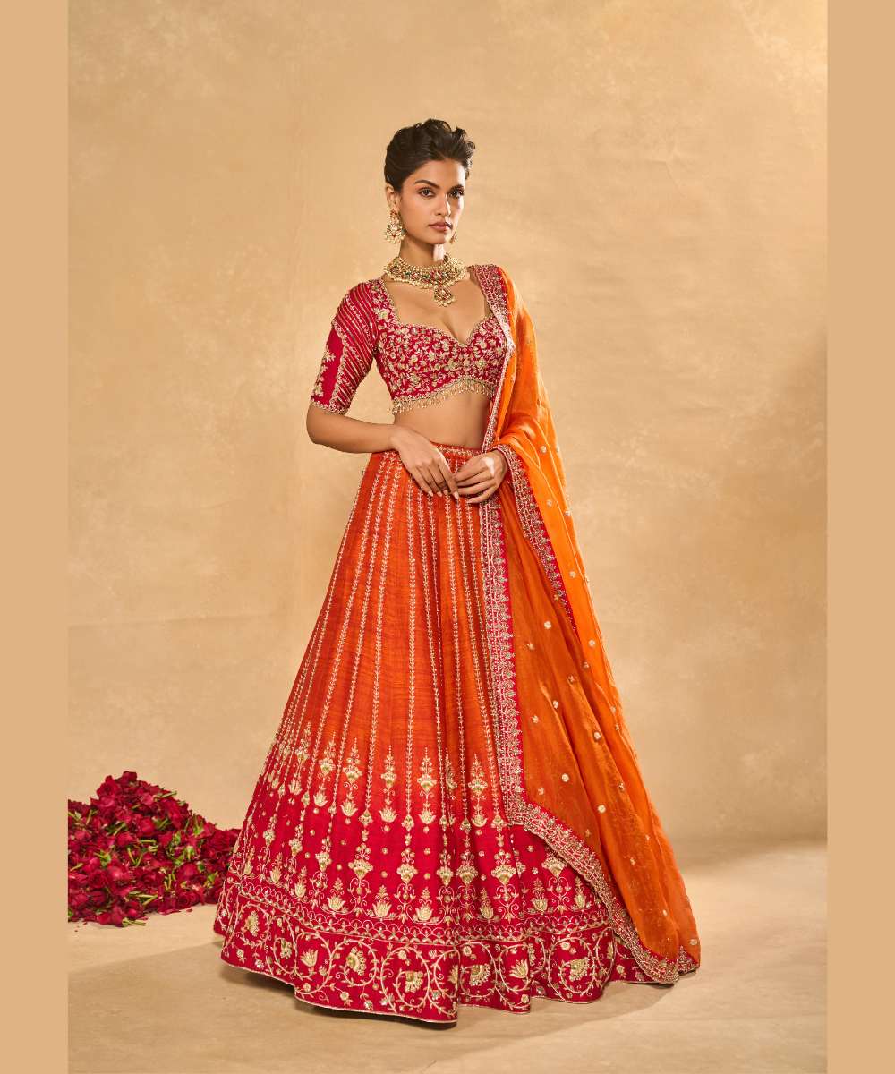 AARIANA LEHENGA - Orange to red ombré raw silk lehenga intricately embellished with zardozi, sequence ,glass beads and pearls paired with a delicately encrusted elbow-sleeve blouse - Leher by Chamee and Palak