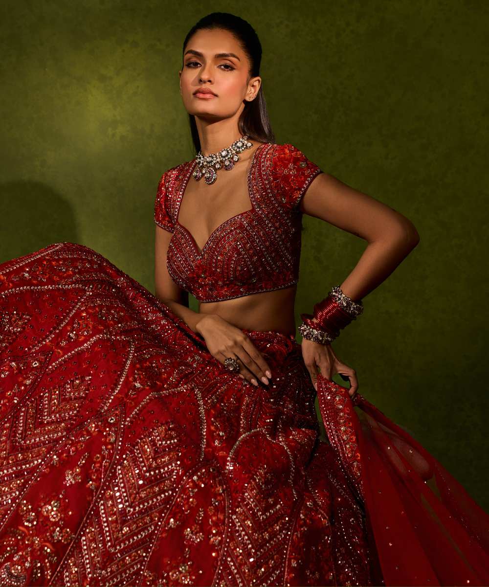 INDIRA LEHENGA - Red raw silk floral embroidered lehenga with thread, sequence, zardozi and glassbeads detailing paired with a sweetheart neck cap sleeve heavily embroidered blouse - Leher by Chamee and Palak