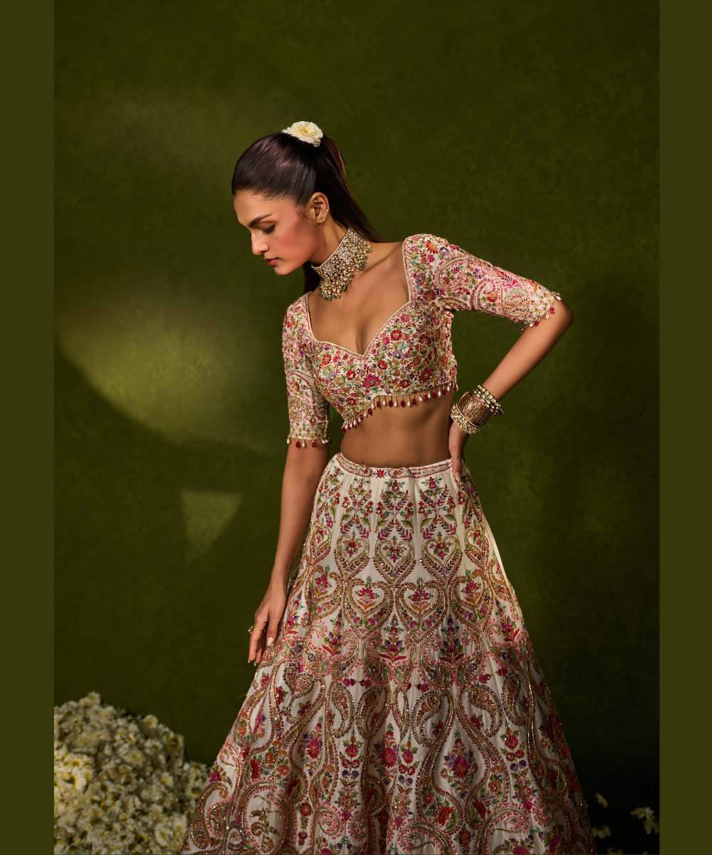 SAISHA LEHENGA - Ivory raw silk lehenga embellished with intricate floral and paisley motifs crafted in resham, zardozi, sequence -  Leher by Chamee and Palak