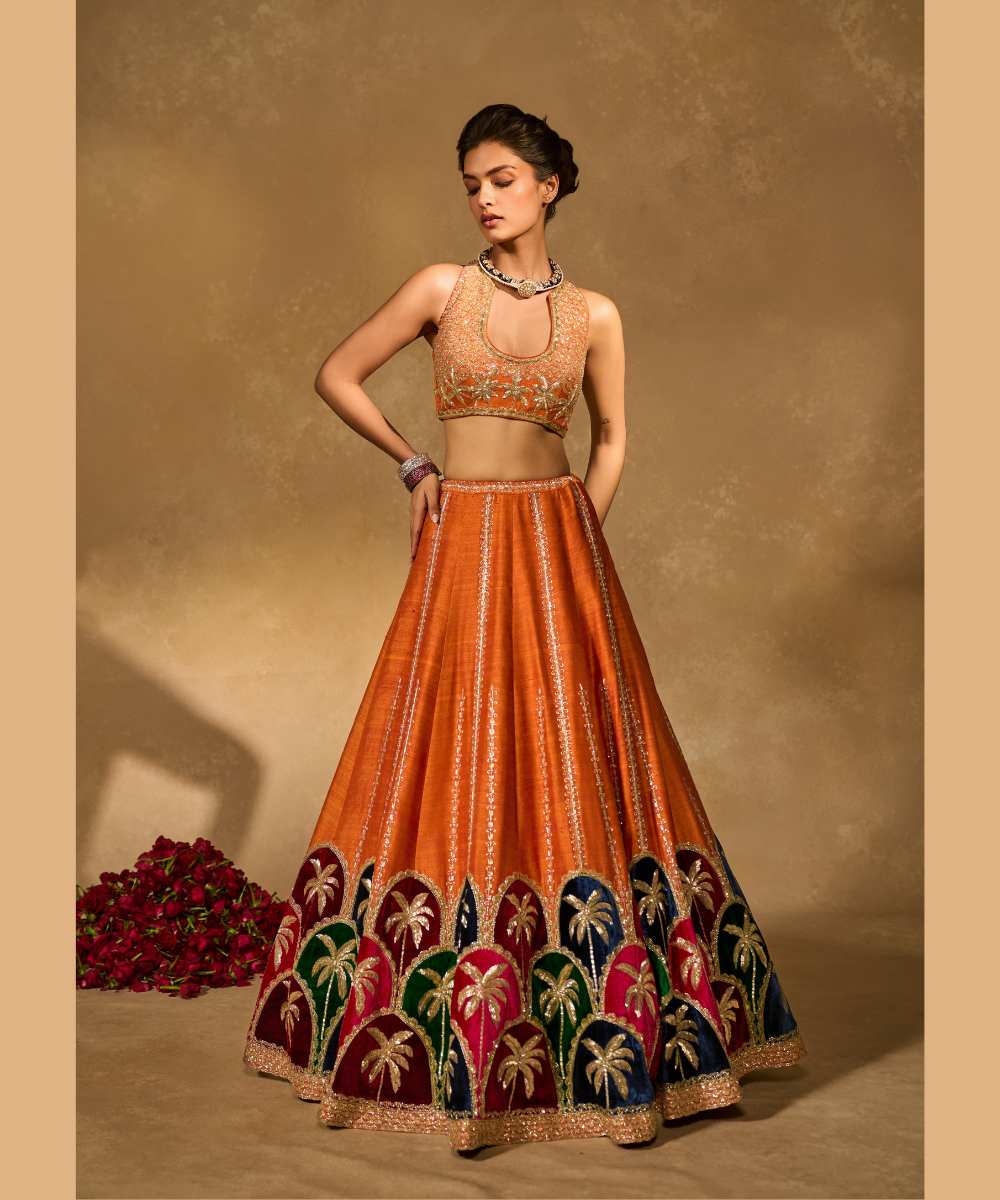 MAPLE LEHENGA - Raw silk lehenga with finely embroidered velvet palm appliqué in blue, maroon, green, and pink, highlighted with glass beads paired with a delicately embellished high-neck décolleté plunge blouse - Leher by Chamee and Palak